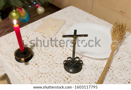 Pastoral visit articles on a table: cross, holy water, sprinkler and envelope with donation. Tradition of catholic church in Poland called koleda