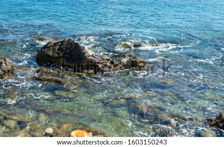 Rock in the surf of the sea at the coast of Sicily
