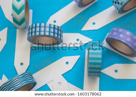 Colorful washi tape rolls flat lay on a pastel background, top down