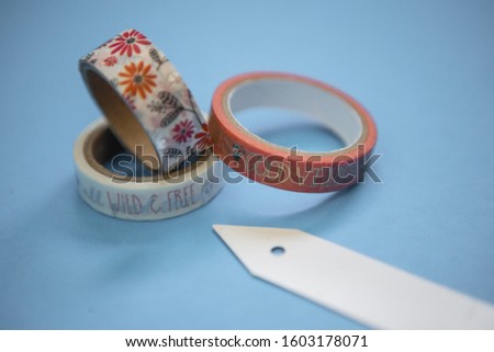Colorful washi tape rolls flat lay on a pastel background, top down