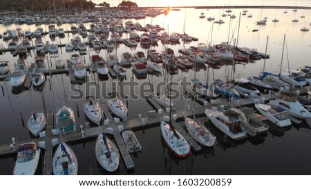 Aerial view of boat dock, yachts. Sunny morning, summer, sunlight