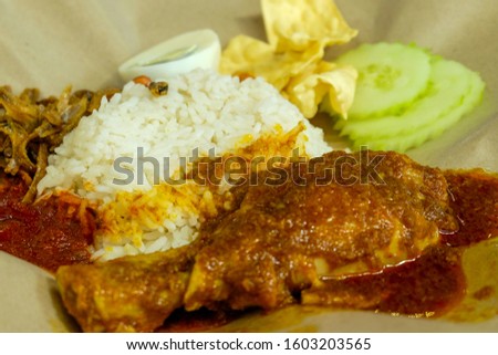 A picture of cafe style "nasi lemak rendang" for breakfast.