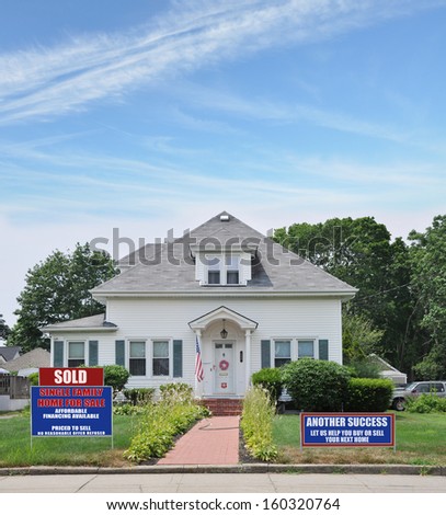 Sold Another Success Real Estate For Sale Sign Front Yard lawn Suburban Bungalow Cottage Style home USA blue sky clouds