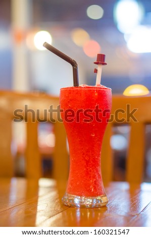 Picture of red shake glass in beach restaurant in evening