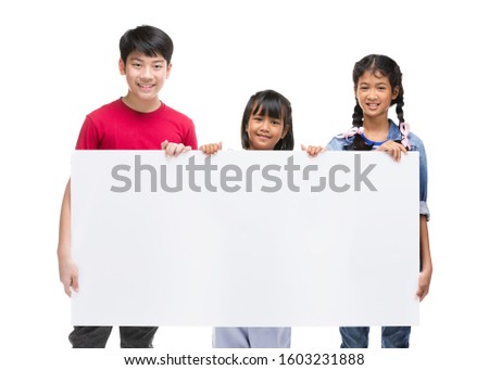 Asian child holds blank sign. Teen boy  and girl holds empty billboard.  Advertising of Teen’s goods.