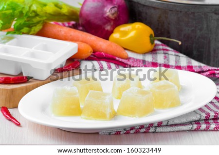 Homemade frozen chicken vegetable broth ice cubes, preparation for future