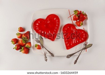 Delicious strawberry gelatin dessert heart shape for couple. Valentines Day concept.