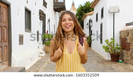 Beautiful young traveler girl visits small town of Betancuria, Canary Islands, Spain