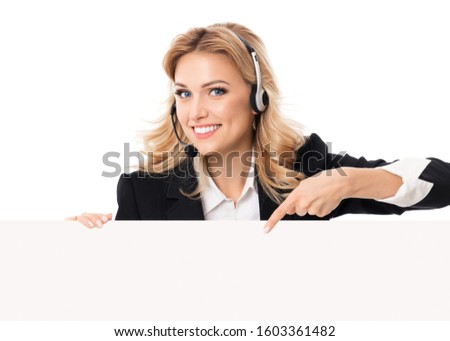 Call center. Customer support service female phone operator in headset pointing signboard with copy space area for text or advertise slogan, isolated over white background.