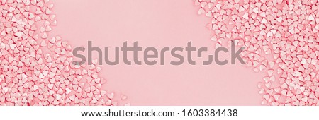 Trendy shining silver candy pink hearts background of cake sprinkles in flat lay with copy space, for feminine blogger or festive love and Valentine's Day concept. Long banner mockup