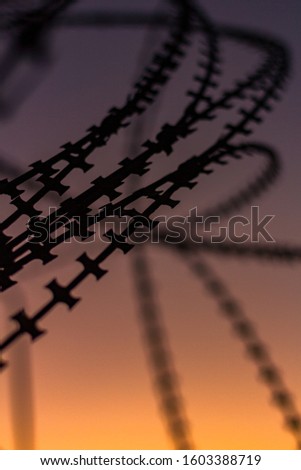 Silhouette Razor Barbed Tape Wire 
And light in the evening.