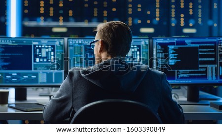IT Specialist Working on Personal Computer with Monitors Showing Coding Language Program. Technical Room of Data Center with Server Rack. Royalty-Free Stock Photo #1603390849