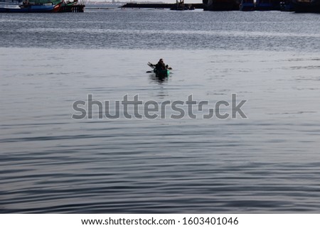 the fisherman searches for fish with his small boat in the sea. minimalist photo concept of fisherman activity