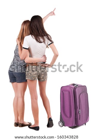 Two young women traveling with suitcas rear view. Isolated over white.