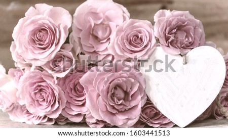 Heart in white for writing with bouquet of roses
