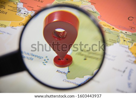 Kochi city in focus with GPS Location tag icon through a magnify glass on India Map India Map world atlas