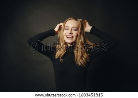 Wawe hair. Portrait of happy emotional young beautiful girl laughing. Off camera. Copy space.