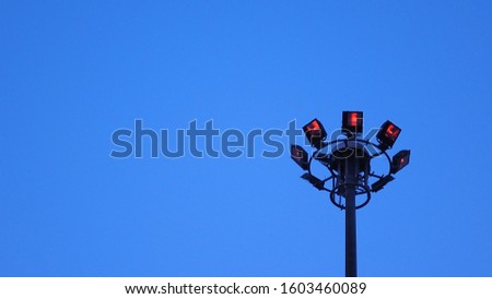 outdoor stadium lights with clear blue sky background.  Sport light pole. Turning off the light.