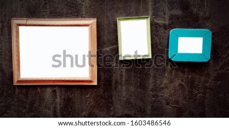 Many empty colorful picture frame mock up on black wall with  copy space for add or fill text in vintage tone. 
