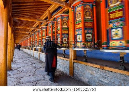 Tibetan prayer wheels at Labrang Monastery in Xiahe County, China.  Translation text written in sanskrit means "jewel in the lotus"
