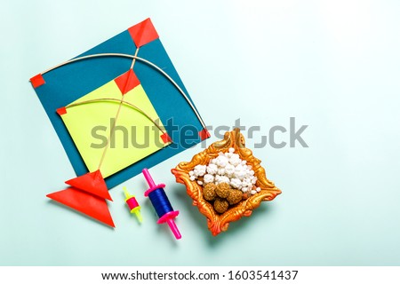 Celebrate Indian festival makar sankranti with colorfull kite,sesame seed ball,tilgul and chakri with background Royalty-Free Stock Photo #1603541437