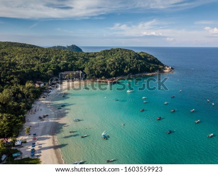 beach full of boats on a calm surface 