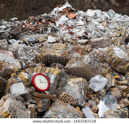 Garbage dump. Broken clock in the garbage on the landfill.