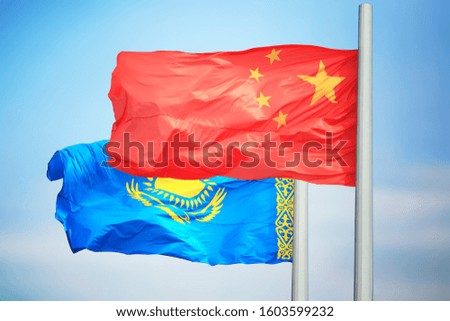Kazakhstan and China flags against the background of blue sky