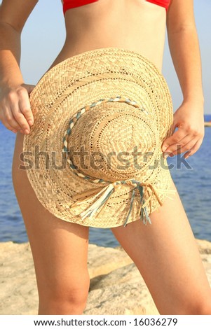 Pretty girl with panama hat on the beach.