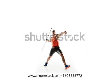 Male athlete practicing in throwing javelin isolated on white studio background. Professional sportsman training in motion, action. Concept of healthy lifestyle, movement, activity. Copyspace. Royalty-Free Stock Photo #1603638772