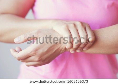 Women's pink shirt with arm pain.Health care and medical concept.