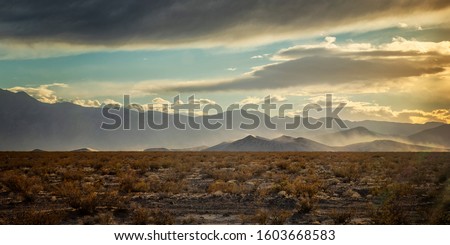 Horizontal Color Image of a sunset with heavy wind over Big Dune in Nevada Royalty-Free Stock Photo #1603668583