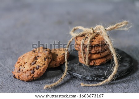 Photo of cookies on a wooden table. Homemade chocolate chip cookies. Biscuits. Studio shot. Rustic background. Vintage. Bright. Image