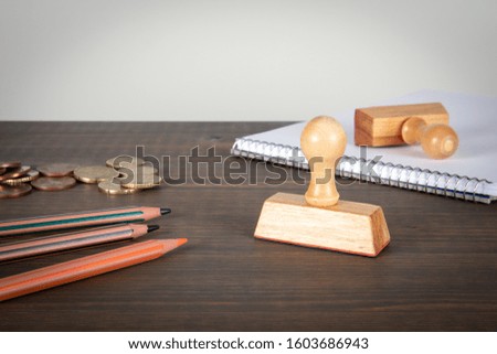 Stamps, stationery, note pad and euro cents on wooden table. Copy space. Background for advertising and information
