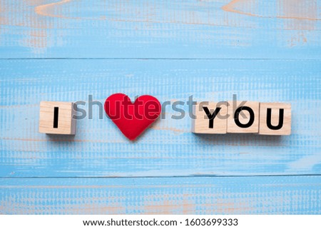 I LOVE YOU wooden cubes with red heart shape decoration on blue table background and copy space for text. Love, Romantic and Happy Valentine’s day holiday concept