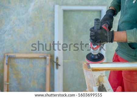Man working to restore old wooden windows