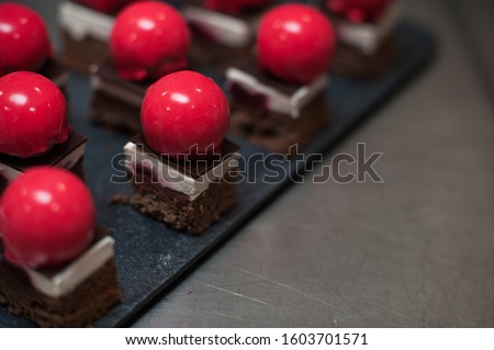 French mousse cakes with mirror glaze. Modern european dessert. Preparation of tasty mousse cake. cooking, baking and confectionery concept