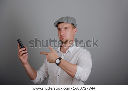 Portrait Of Happy Young Man Talking On Cell Phone Isolated On gray Background