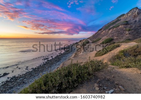 Long exposure photo of Southern California coastline after sunset with dramatic clouds in the sky, Bluff Cove, Palos Verdes Estates, California