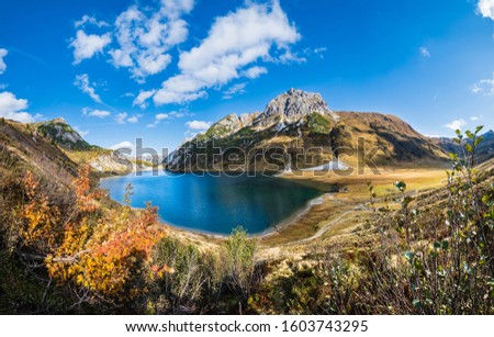 Sunny autumn alpine Tappenkarsee lake and rocky mountains above, Kleinarl, Land Salzburg, Austria. Picturesque hiking, seasonal, and nature beauty concept scene.