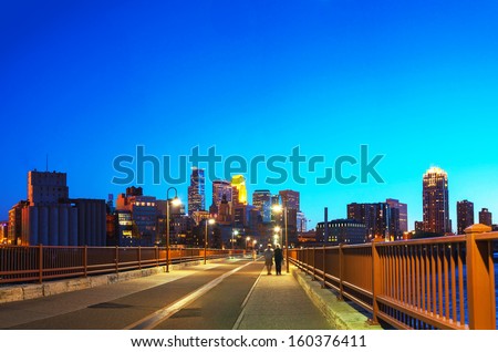 Downtown Minneapolis, Minnesota at night time as seen from the famous Stone Arch bridge