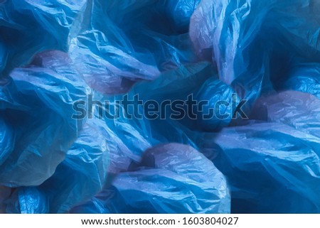 Abstract blue background made of plastic bags. Concept of Recycling plastic and ecology. Concept zero waste. Flat lay, top view, copy space