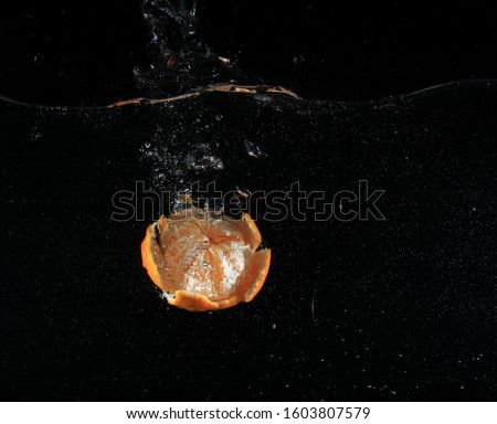 open tangerine orange in water