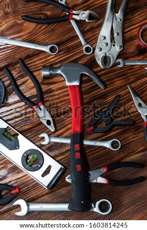Close up tools on a wooden background.