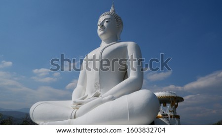 White Buddha statue with the background of blue sky