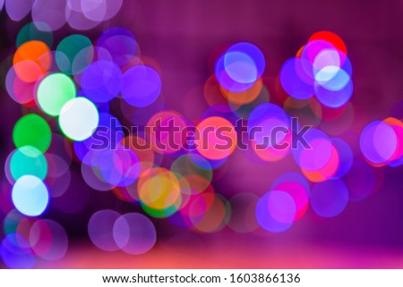 Bokeh colorful multi-colored lights yellow red blue green. Lights from Christmas garlands defocused in beautiful bokeh. Copy space on background of multi-colored flashlights in blurry focus.