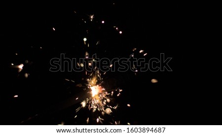 The picture shows two lit sparklers