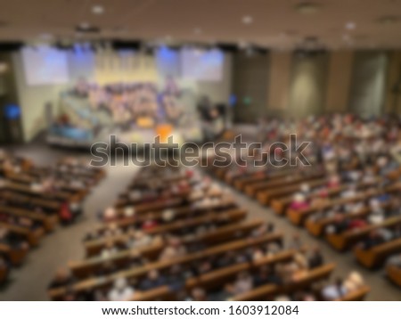 Abstract blur of inside of mega church during sermon. Royalty-Free Stock Photo #1603912084