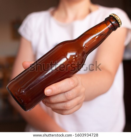 Woman with beer bottle in her hand