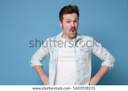 Wow I am suprised. Attractive man with retro mustache standing with open mouth. Human emotions, facial expression concept. Royalty-Free Stock Photo #1603938235